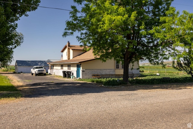 10205 W 10400 N, Tremonton, UT 84337 - view of property hidden behind natural elements featuring a chimney and brick siding