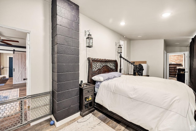 10205 W 10400 N, Tremonton, UT 84337 - bedroom with wood finished floors, a barn door, and recessed lighting