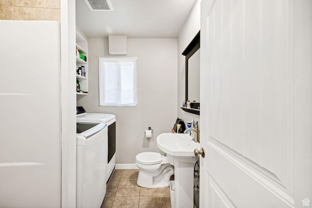 10205 W 10400 N, Tremonton, UT 84337 - bathroom with washer and dryer, toilet, tile patterned floors, baseboards, and a sink