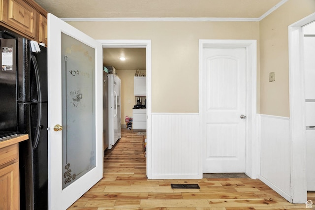 10205 W 10400 N, Tremonton, UT 84337 - kitchen with freestanding refrigerator, a wainscoted wall, light wood-style flooring, and crown molding