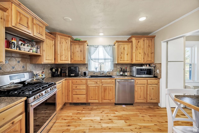 10205 W 10400 N, Tremonton, UT 84337 - kitchen with stainless steel appliances, a sink, light wood-style flooring, plenty of natural light, and crown molding