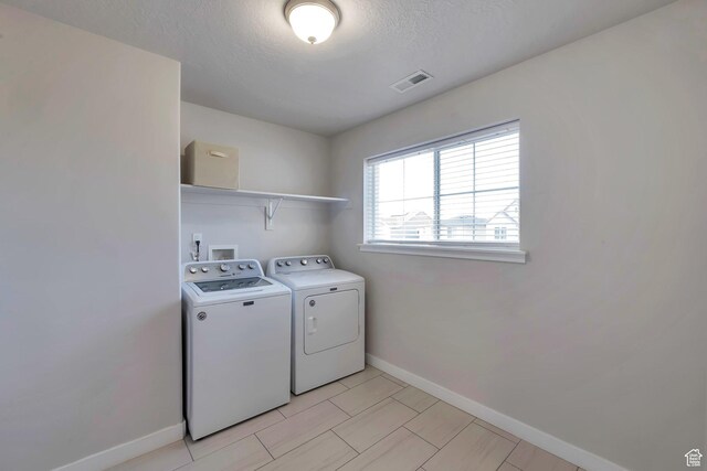 945 W Mckenna Rd, Bluffdale, UT 84065 - washroom featuring washing machine and dryer, baseboards, and a textured ceiling