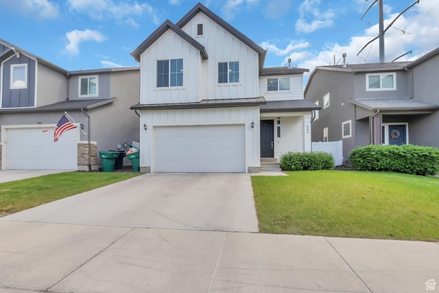 945 W Mckenna Rd, Bluffdale, UT 84065 - view of front of house featuring board and batten siding, a garage, a front lawn, driveway, and a standing seam roof