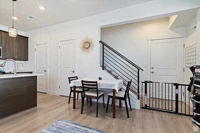 11764 S Leander Rd Unit 578, South Jordan, UT 84009 - dining area with light wood-type flooring, stairs, and recessed lighting