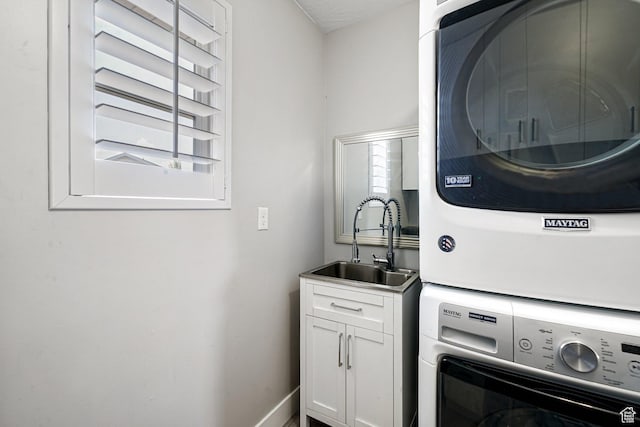 149 E 230 N, Vineyard, UT 84059 - laundry room with stacked washing machine and dryer, cabinet space, and baseboards