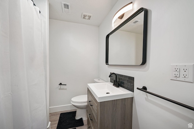 149 E 230 N, Vineyard, UT 84059 - bathroom featuring vanity, toilet, wood finished floors, baseboards, and decorative backsplash