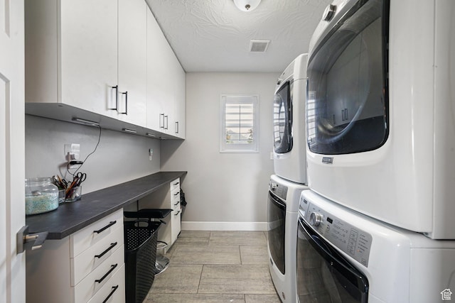 149 E 230 N, Vineyard, UT 84059 - laundry room with stacked washer / dryer, cabinet space, baseboards, and a textured ceiling