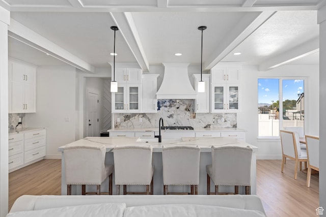 648 W 400 N, Mapleton, UT 84664 - kitchen featuring premium range hood, backsplash, a kitchen breakfast bar, light wood-type flooring, and beamed ceiling