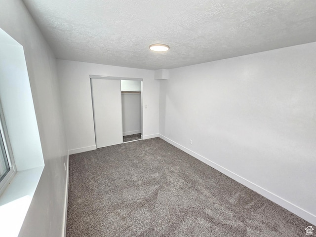 8181 W Danbury Dr, Magna, UT 84044 - unfurnished bedroom with carpet floors, baseboards, a closet, and a textured ceiling