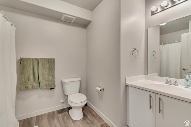 1700 Sandhill Rd Unit H301, Orem, UT 84058 - bathroom featuring toilet, wood finished floors, baseboards, and vanity