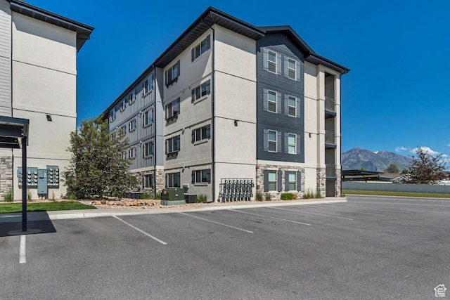 1700 Sandhill Rd Unit H301, Orem, UT 84058 - view of building exterior featuring uncovered parking and a mountain view