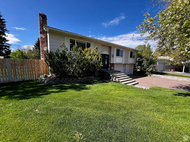 130 Cascade Quey St, Soda Springs, ID 83276 - raised ranch featuring a garage, a chimney, and decorative driveway