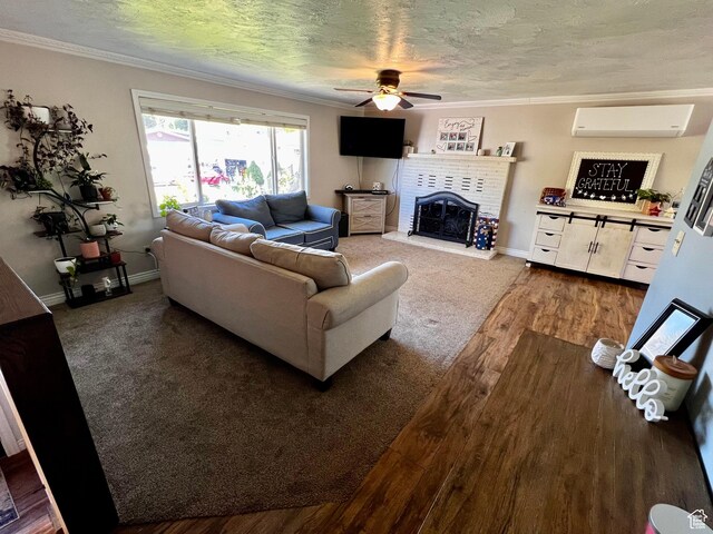 130 Cascade Quey St, Soda Springs, ID 83276 - living room featuring a wall mounted AC, ceiling fan, wood finished floors, ornamental molding, and a brick fireplace