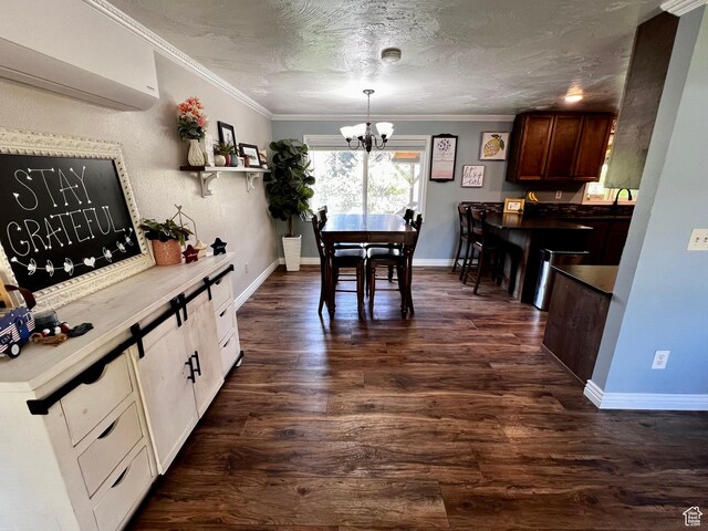 130 Cascade Quey St, Soda Springs, ID 83276 - dining space featuring a chandelier, an AC wall unit, ornamental molding, dark wood-type flooring, and baseboards