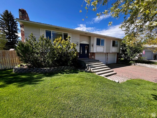 130 Cascade Quey St, Soda Springs, ID 83276 - raised ranch featuring an attached garage, a chimney, and decorative driveway
