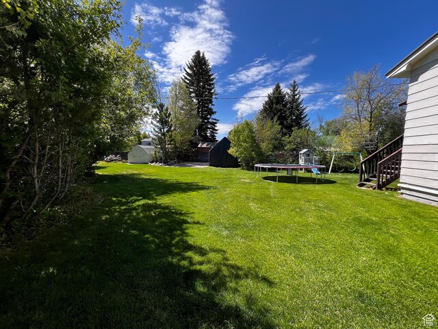 130 Cascade Quey St, Soda Springs, ID 83276 - view of green lawn featuring a trampoline and stairway