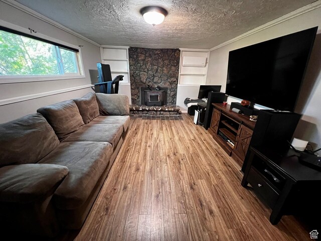 130 Cascade Quey St, Soda Springs, ID 83276 - living room featuring wood finished floors, built in features, a textured ceiling, crown molding, and a wood stove
