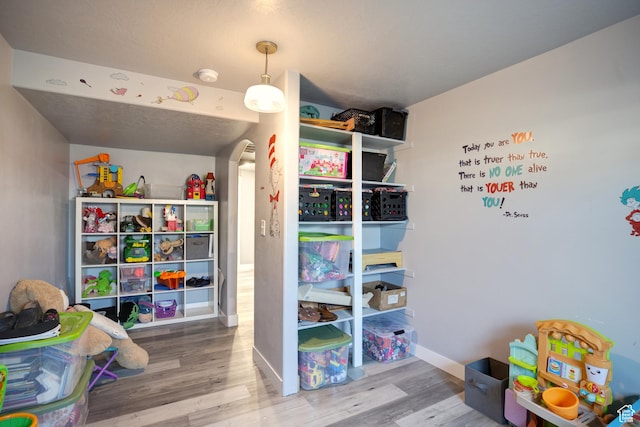 343 W Deer Creek Trl, Salem, UT 84653 - recreation room featuring wood finished floors, arched walkways, and baseboards