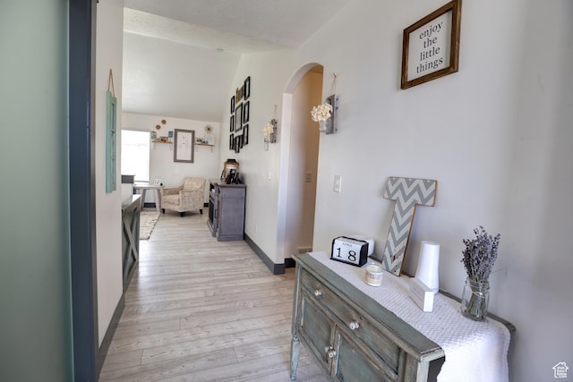 343 W Deer Creek Trl, Salem, UT 84653 - hallway with arched walkways, light wood finished floors, vaulted ceiling, and baseboards