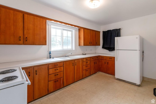 1463 E 12300 N, Cove, UT 84320 - kitchen with freestanding refrigerator, a sink, light countertops, range, and brown cabinets