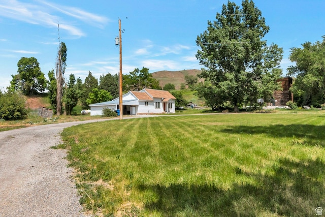 1463 E 12300 N, Cove, UT 84320 - view of front of home featuring a front yard, a mountain view, and driveway