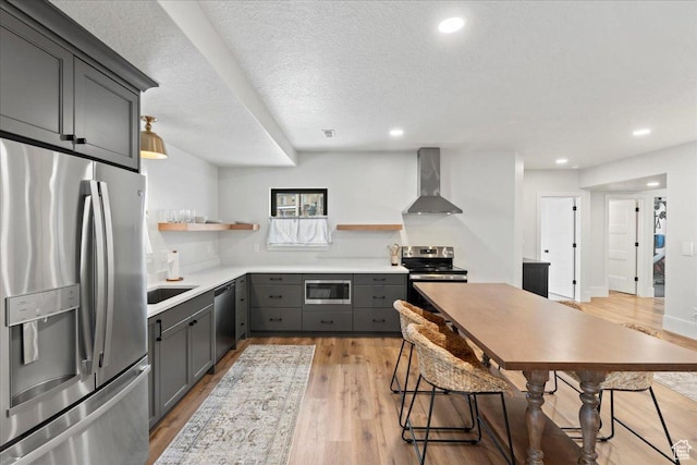 3651 N 200 E, North Ogden, UT 84414 - kitchen with stainless steel appliances, wall chimney exhaust hood, open shelves, gray cabinetry, and light wood finished floors