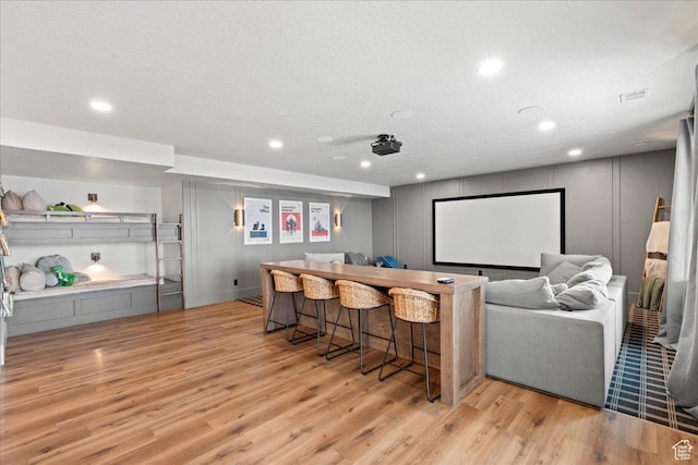 3651 N 200 E, North Ogden, UT 84414 - cinema room featuring light wood-style floors, recessed lighting, a dry bar, and a textured ceiling