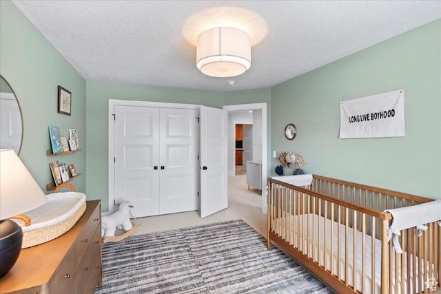 3651 N 200 E, North Ogden, UT 84414 - bedroom featuring a closet, carpet, a textured ceiling, and a crib