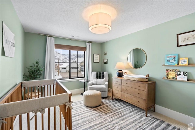 3651 N 200 E, North Ogden, UT 84414 - carpeted bedroom featuring a nursery area, a textured ceiling, and baseboards