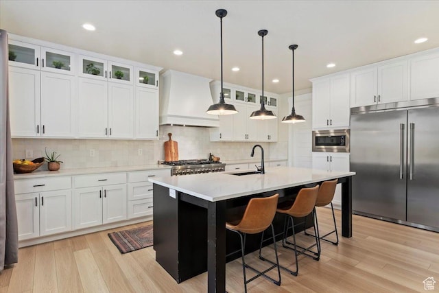 325 N 1200 E, American Fork, UT 84003 - kitchen with built in appliances, a sink, premium range hood, light wood-type flooring, and recessed lighting