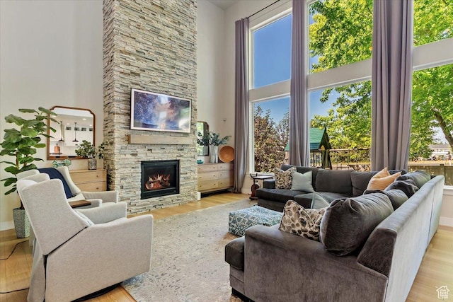 325 N 1200 E, American Fork, UT 84003 - living area with a high ceiling, wood finished floors, a fireplace, and baseboards