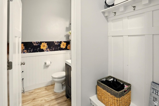 5186 W Hedgerose Dr S, Herriman, UT 84096 - bathroom with wood finished floors, toilet, vanity, and a wainscoted wall