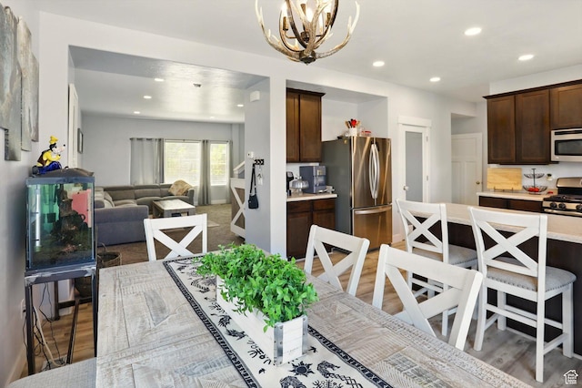 5186 W Hedgerose Dr S, Herriman, UT 84096 - dining space with a chandelier, light wood-type flooring, and recessed lighting