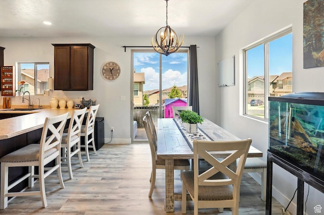 5186 W Hedgerose Dr S, Herriman, UT 84096 - dining space featuring a chandelier, light wood-style floors, recessed lighting, and baseboards