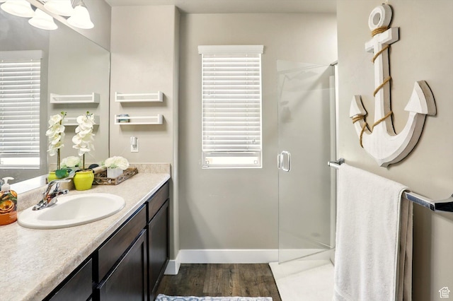 5186 W Hedgerose Dr S, Herriman, UT 84096 - bathroom featuring vanity, a shower stall, wood finished floors, and baseboards