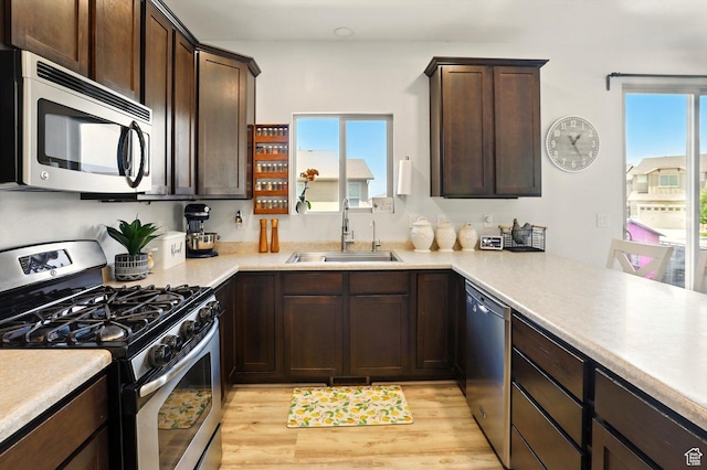 5186 W Hedgerose Dr S, Herriman, UT 84096 - kitchen featuring appliances with stainless steel finishes, a sink, dark brown cabinets, and light countertops