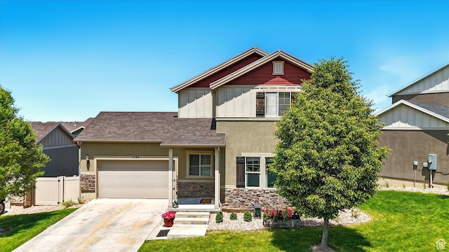 5186 W Hedgerose Dr S, Herriman, UT 84096 - view of front of property featuring driveway, stone siding, an attached garage, stucco siding, and roof with shingles
