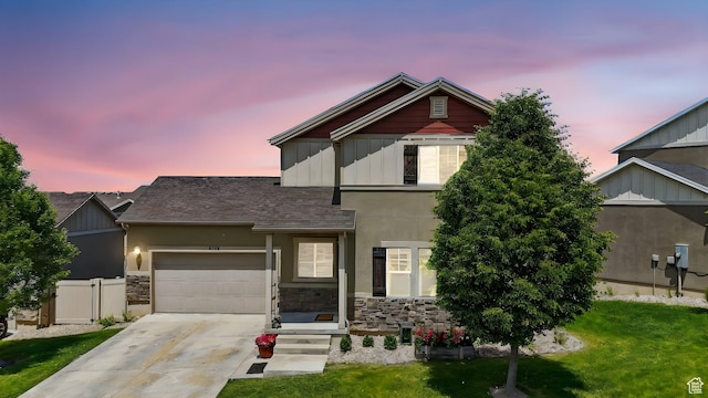 5186 W Hedgerose Dr S, Herriman, UT 84096 - view of front of property featuring an attached garage, concrete driveway, stone siding, roof with shingles, and board and batten siding