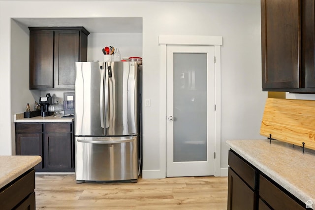 5186 W Hedgerose Dr S, Herriman, UT 84096 - kitchen with freestanding refrigerator, dark brown cabinetry, and light countertops
