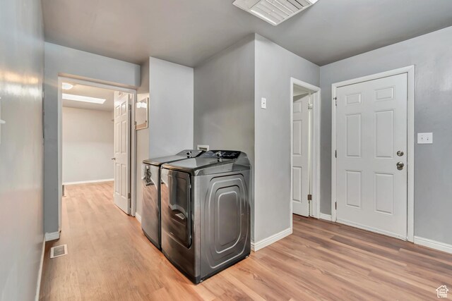3067 W Lemay Ave S, West Valley City, UT 84119 - laundry room featuring light wood-style floors, washing machine and dryer, and baseboards