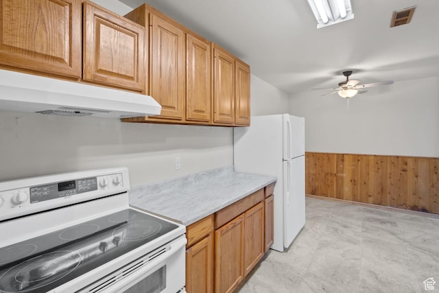 1860 W 500 N Unit 7, Salt Lake City, UT 84116 - kitchen with white appliances, under cabinet range hood, light countertops, ceiling fan, and wood walls