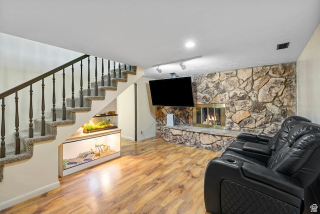 4589 S Trojan Dr, West Valley City, UT 84120 - living area featuring rail lighting, wood finished floors, baseboards, and stairs