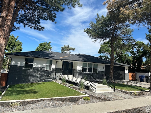 7726 S 3500 E, Cottonwood Heights, UT 84121 - ranch-style home featuring a garage, a front lawn, brick siding, and concrete driveway