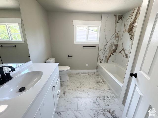 933 E 1150 N, Ogden, UT 84404 - bathroom with vanity, toilet, marble look tiles, baseboards, and shower / tub combination