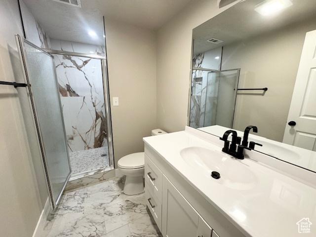 933 E 1150 N, Ogden, UT 84404 - bathroom with toilet, marble look tile flooring, a marble finish shower, and vanity