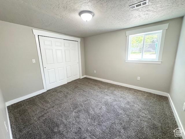 933 E 1150 N, Ogden, UT 84404 - unfurnished bedroom with carpet floors, a textured ceiling, baseboards, and a closet