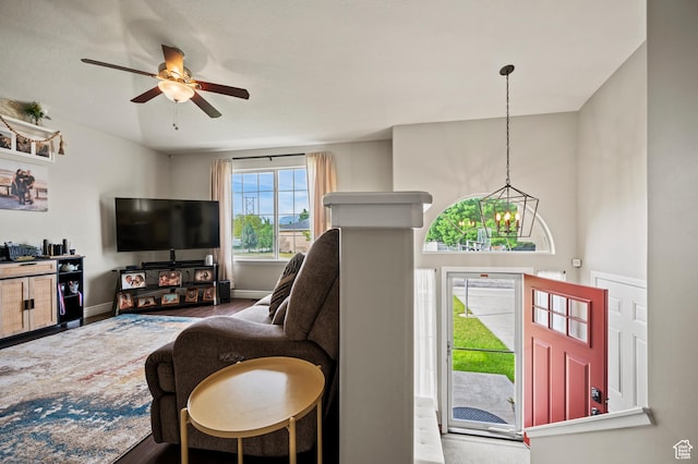 679 W 3600 S, Riverdale, UT 84405 - living area with a ceiling fan, a chandelier, baseboards, and wood finished floors