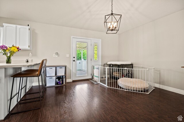 679 W 3600 S, Riverdale, UT 84405 - dining area with baseboards, dark wood-style flooring, and a chandelier