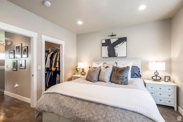 1722 W Naxos Ln, South Jordan, UT 84095 - bedroom with baseboards, a walk in closet, recessed lighting, a closet, and dark wood finished floors