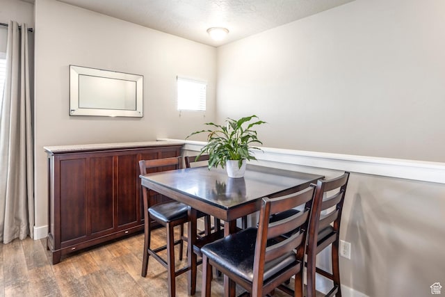 1722 W Naxos Ln, South Jordan, UT 84095 - dining area with light wood-style flooring, a textured ceiling, and baseboards